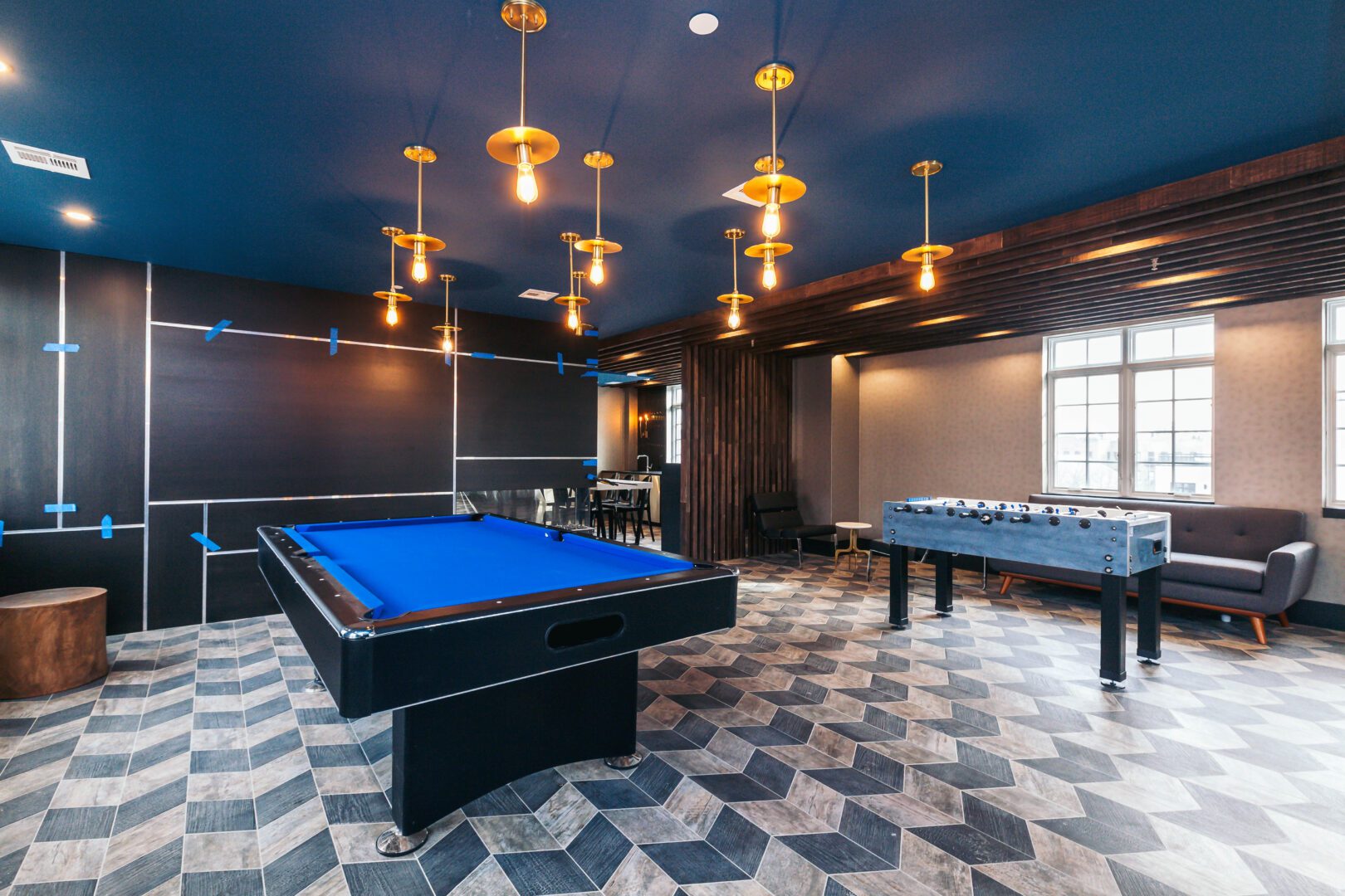 A pool table and ping pong tables in a room.