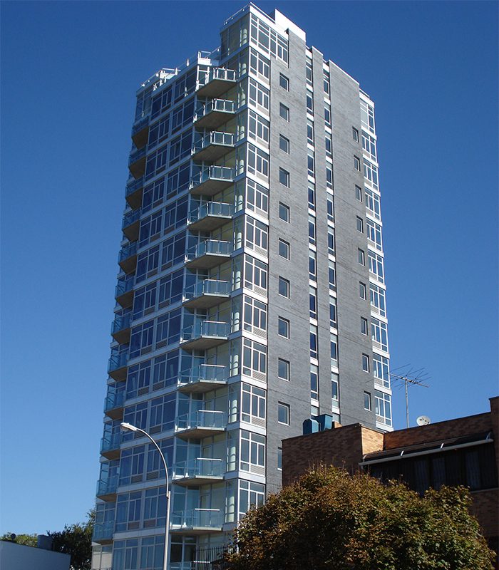 A tall building with many windows on the top of it.