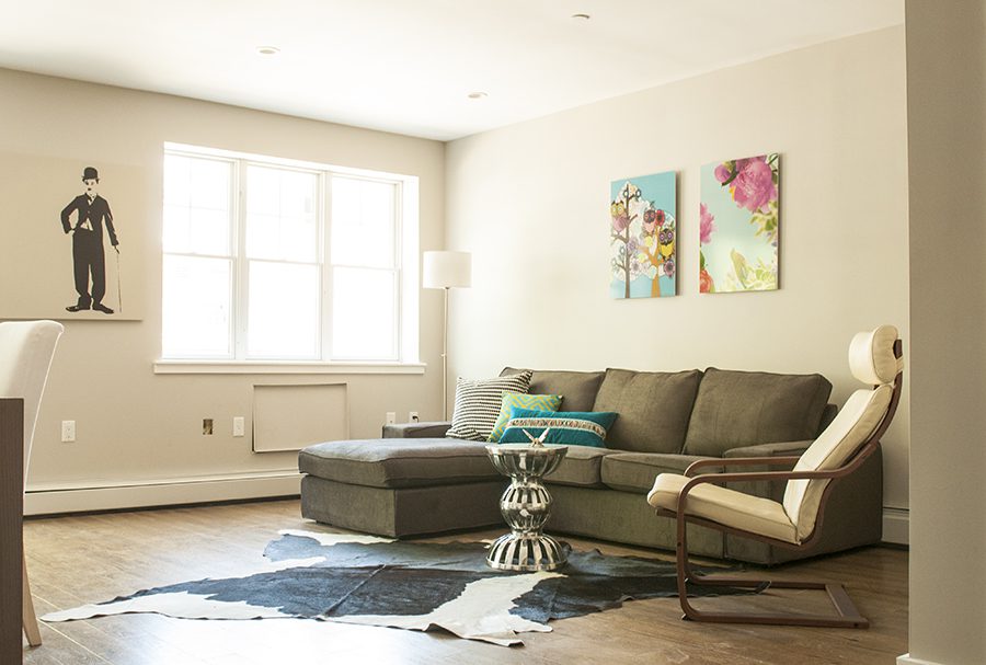 A living room with a couch and chair in it